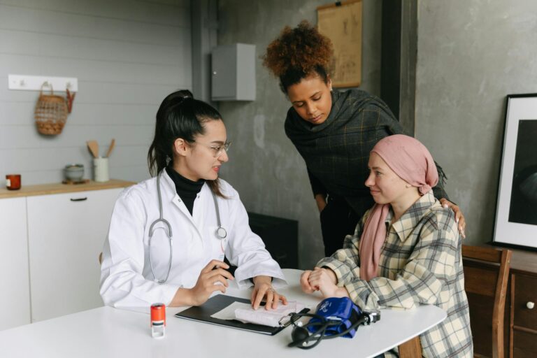 A doctor consulting with cancer patient and caregiver about medical waste handling at home.