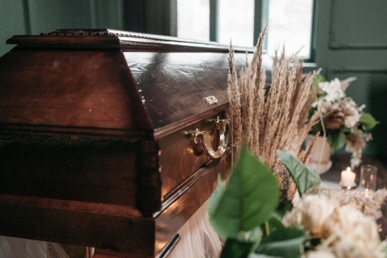 Wooden casket with decorative flowers nearby