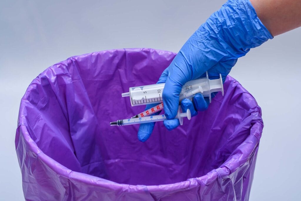 Throwing medical waste and used syringes into the trash is not compliant.